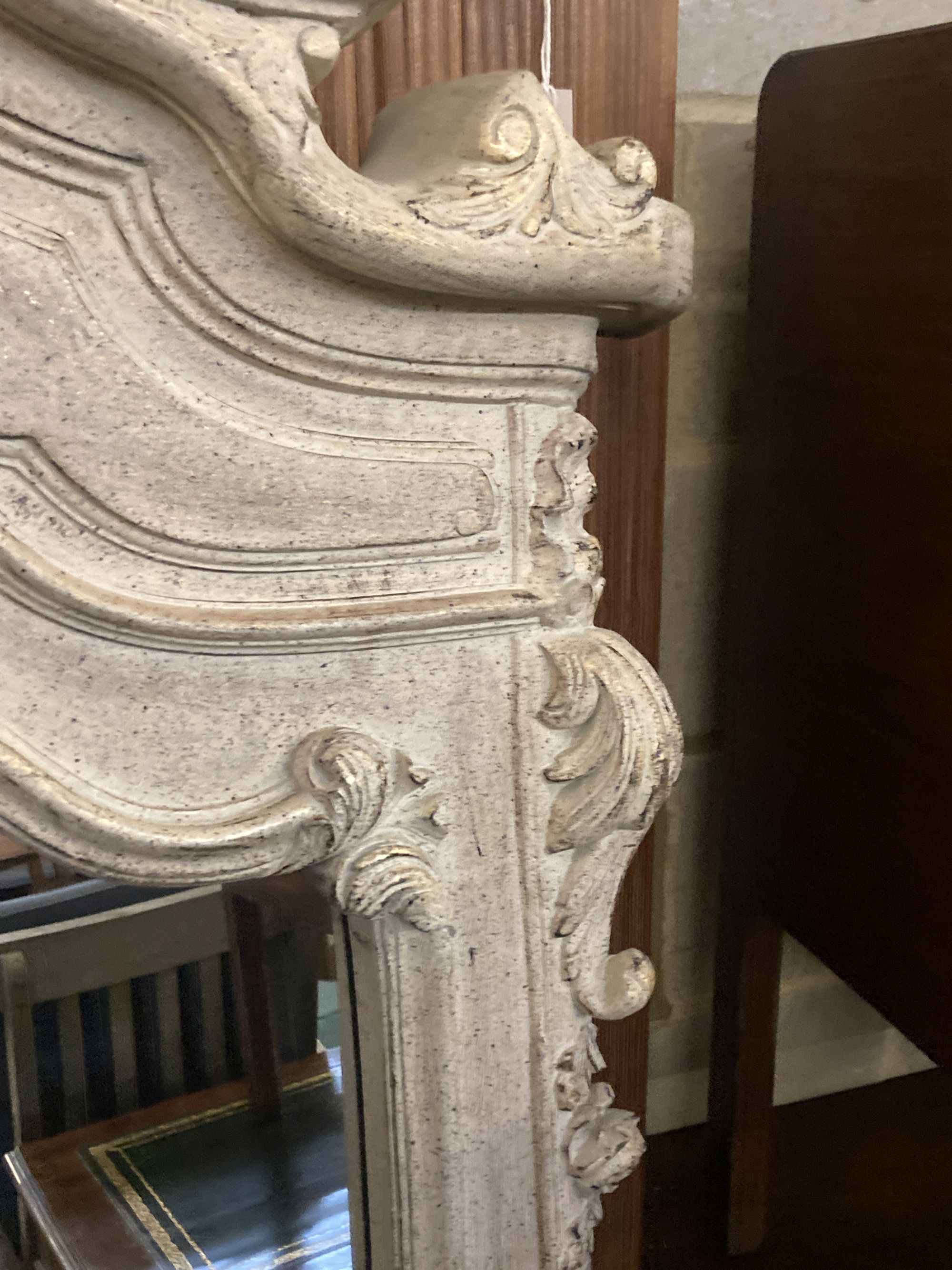 A composition rococo style overmantel mirror, width 100cm height 194cm